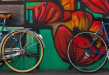 Bikes in front of a wall of graffiti.