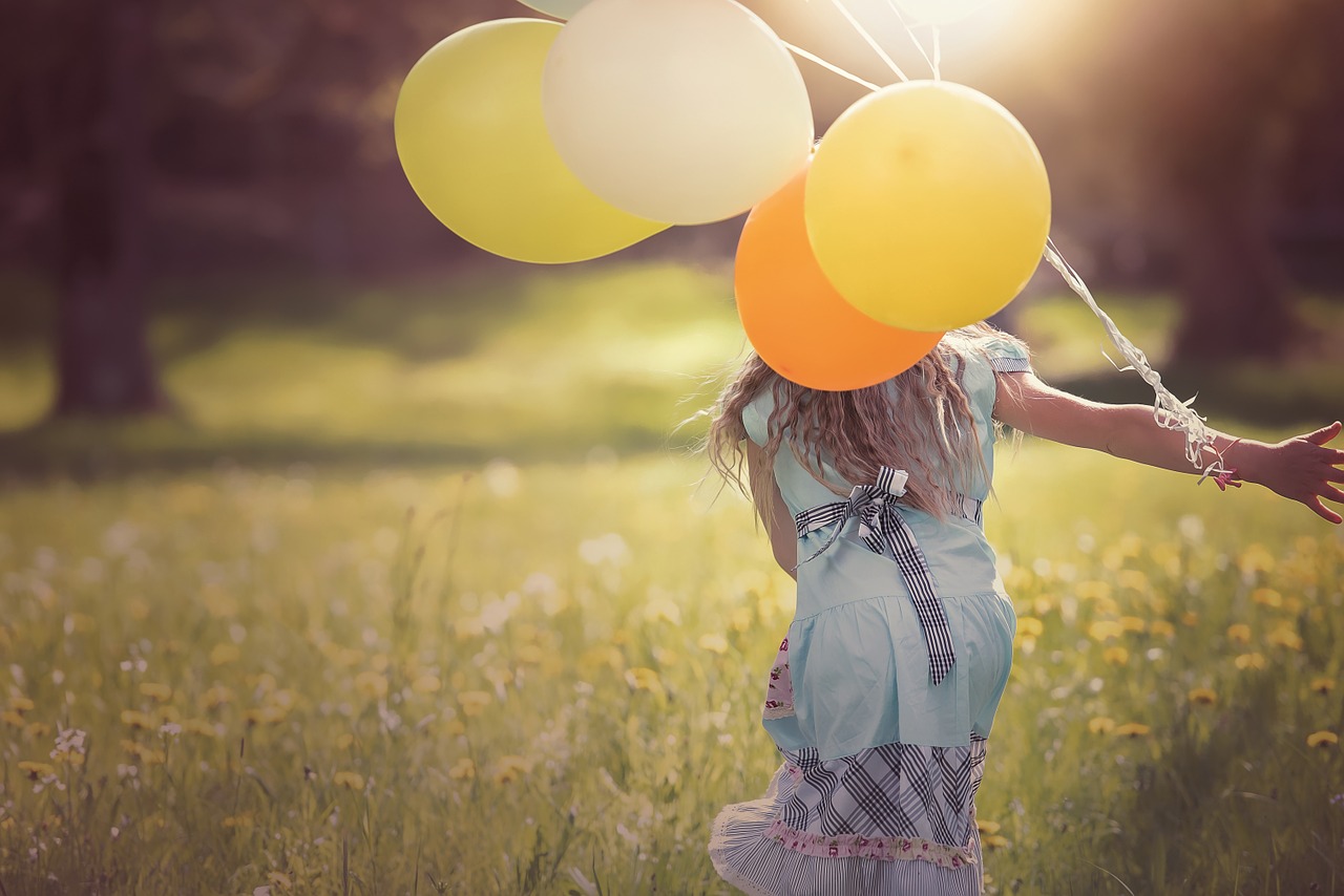 Girl playing with balloons.