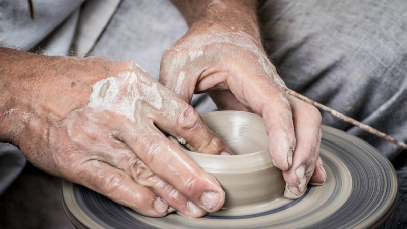 hands sculpting pottery bowl