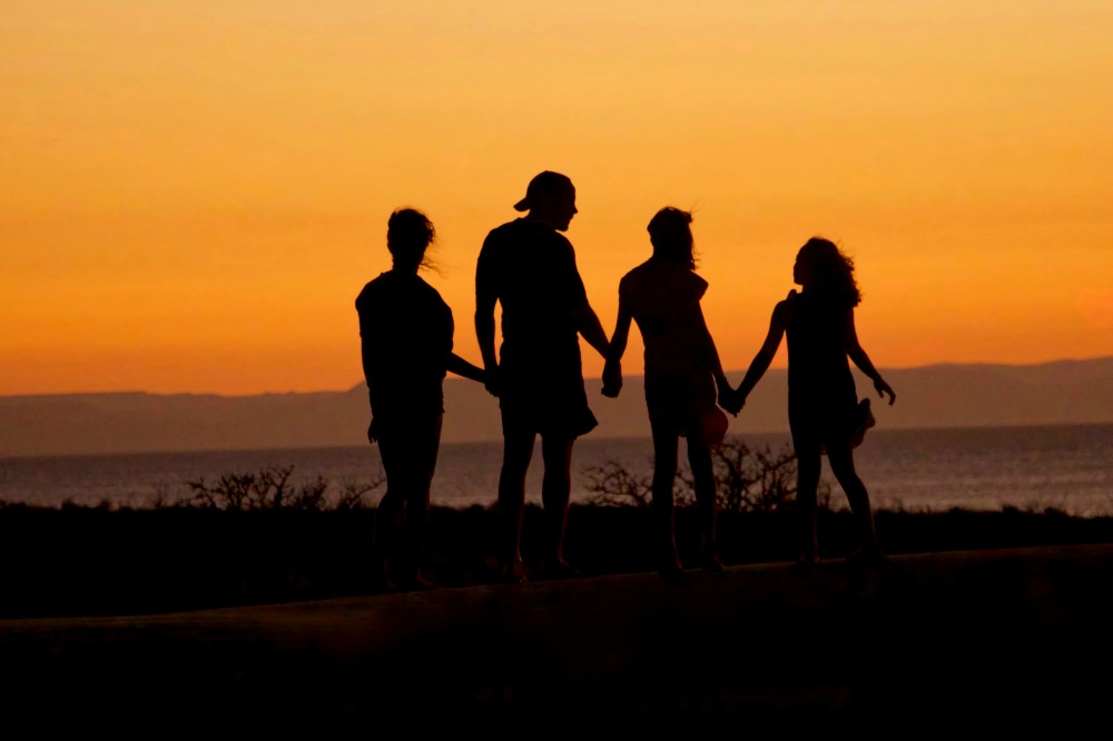 family holding hands at sunset mormon