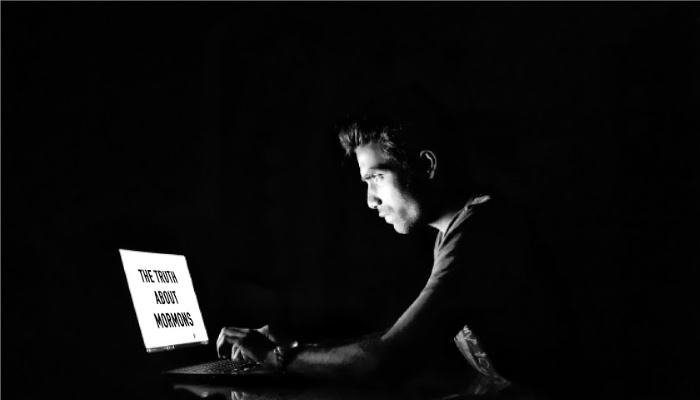 Man at computer with the words, 