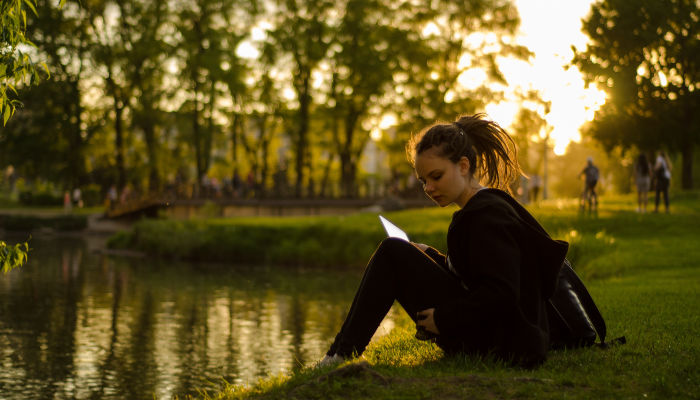 girl reading by pond mormon