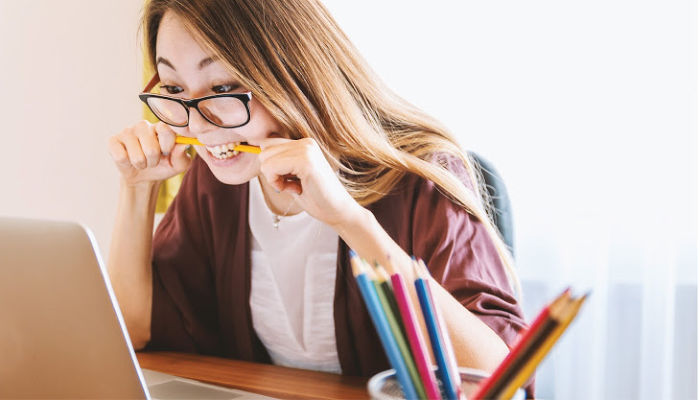 girl nervously biting a pencil