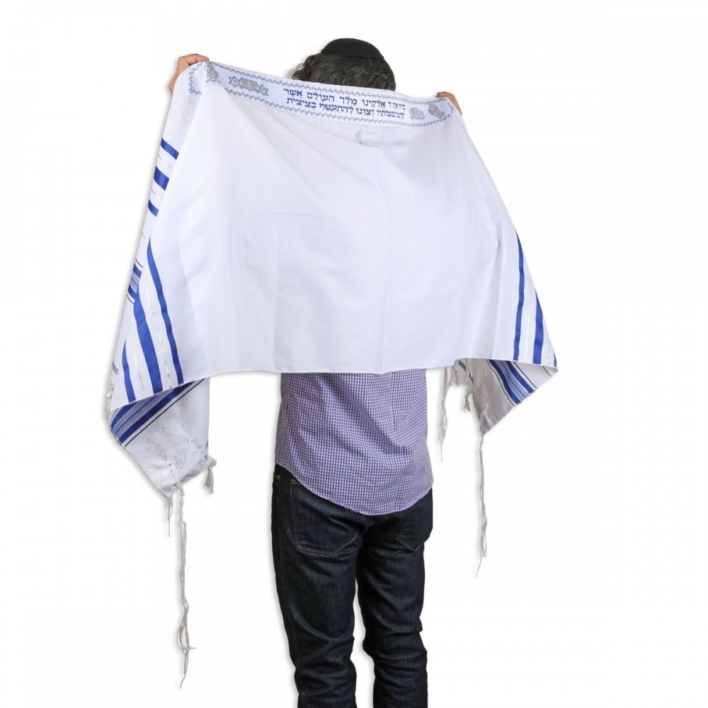 man modeling Jewish prayer shawl