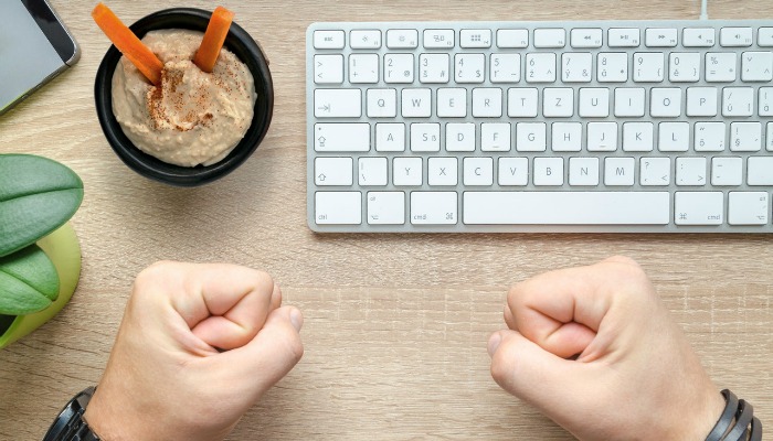 fists on desk with keyboard