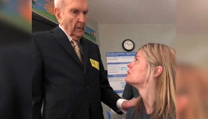 Photo of President Nelson visiting a woman in the hospital.