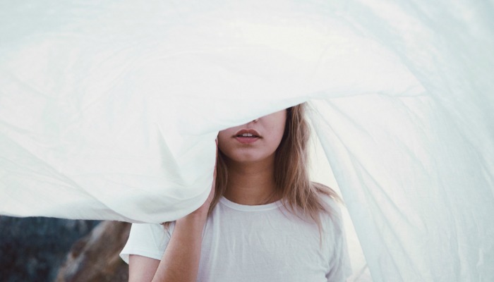 woman hiding anxious