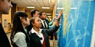 Group of lds missionaries pointing to wall map