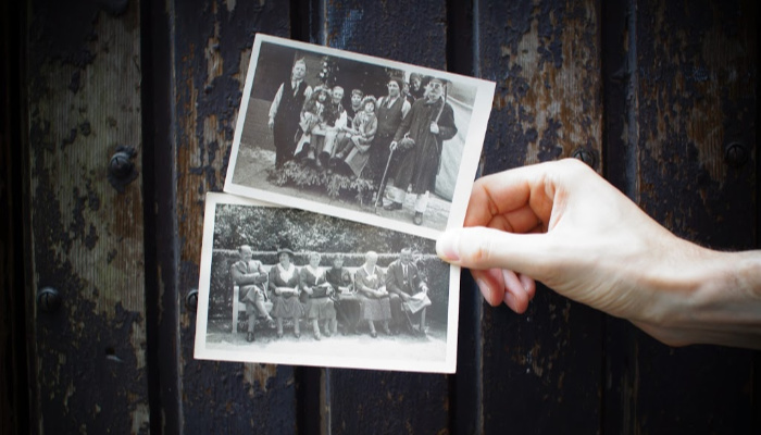 Hand holding two vintage photographs