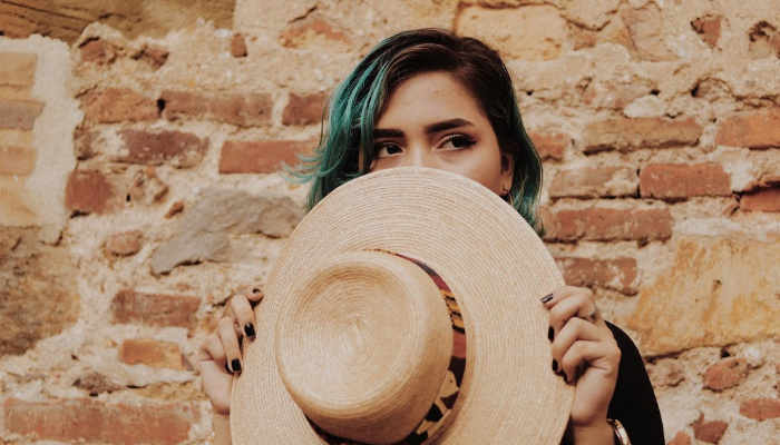 Mormon woman holding hat.