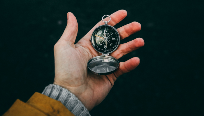 Man holding compass.