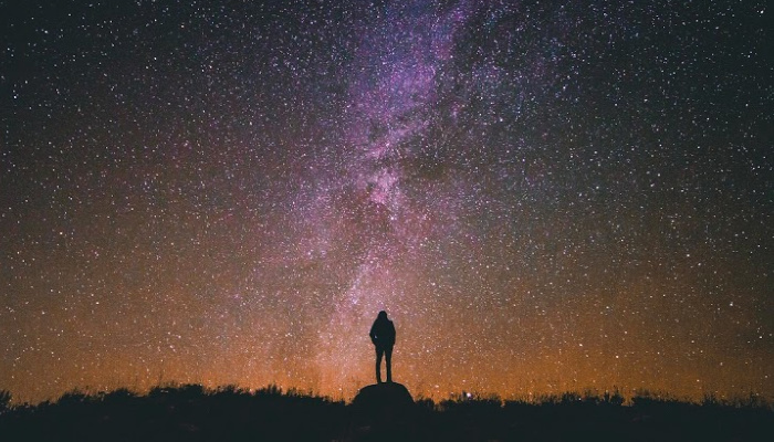 Mormon woman standing under stars receiving revelation.