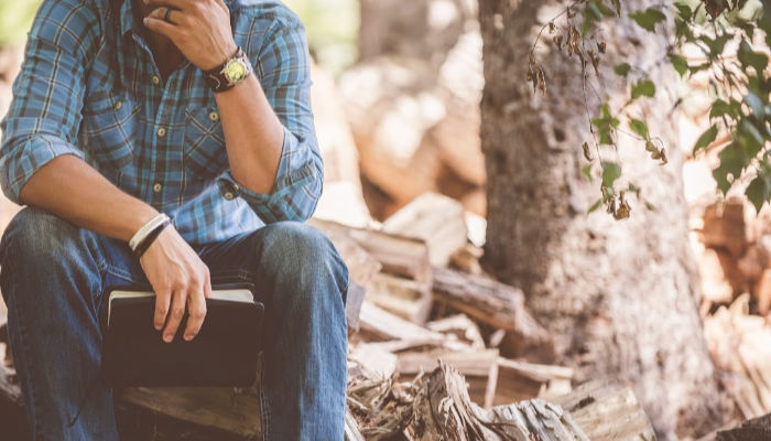 Man sitting with scriptures.