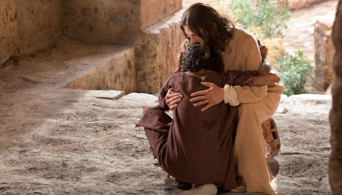 Photo of Jesus Christ hugging a man.