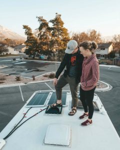 couple on top of truck bed camper