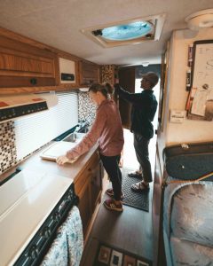 couple inside truck bed camper