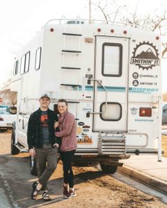 smithin' it standing in front of truck bed camper