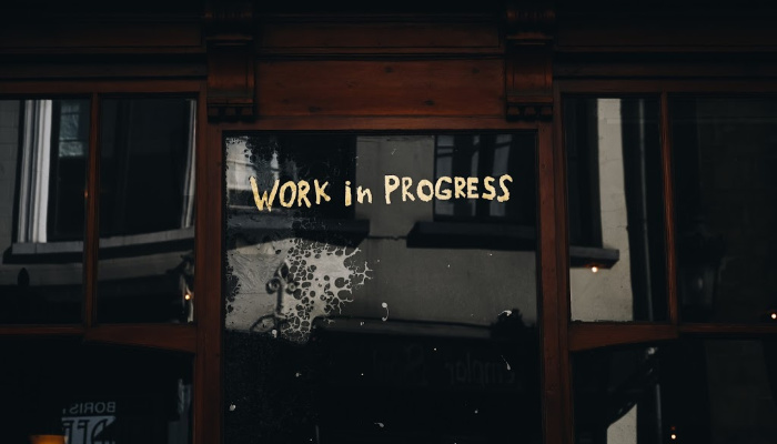 door with writing that says work in progress