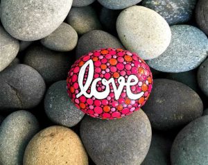 valentine's day painted rock with the word love