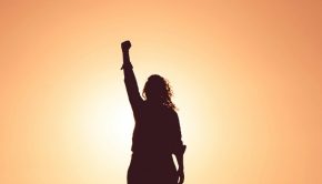 woman standing with fist in air