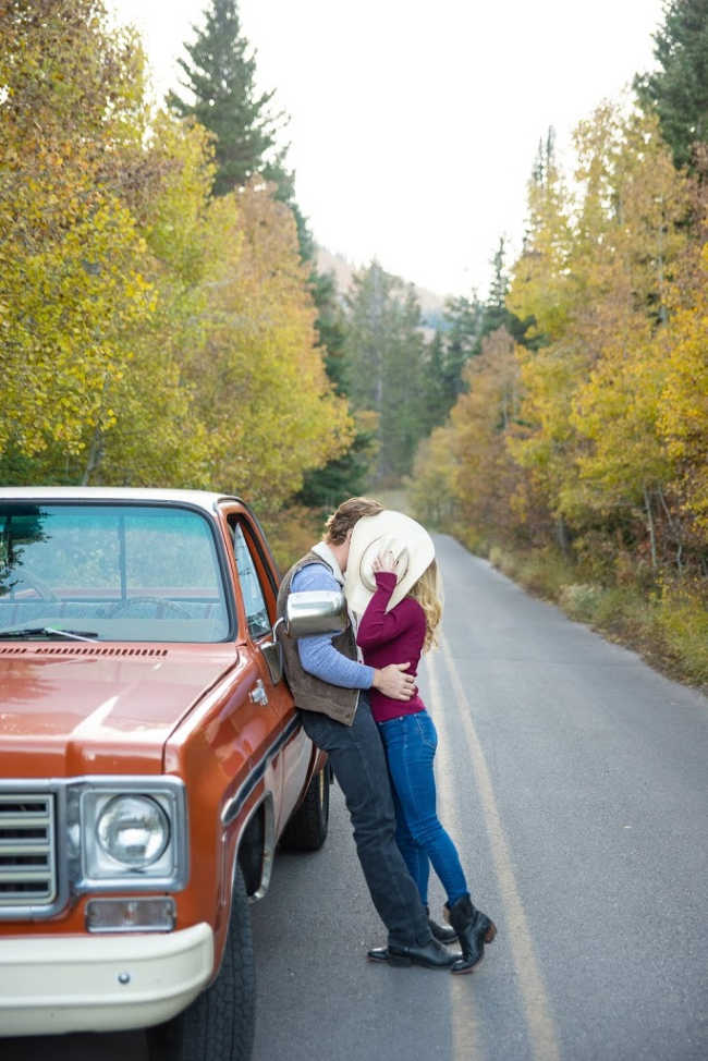 couple kissing next to a truck