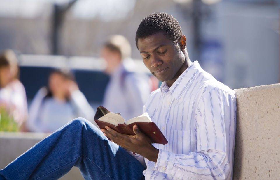 man reading scriptures before working in the temple