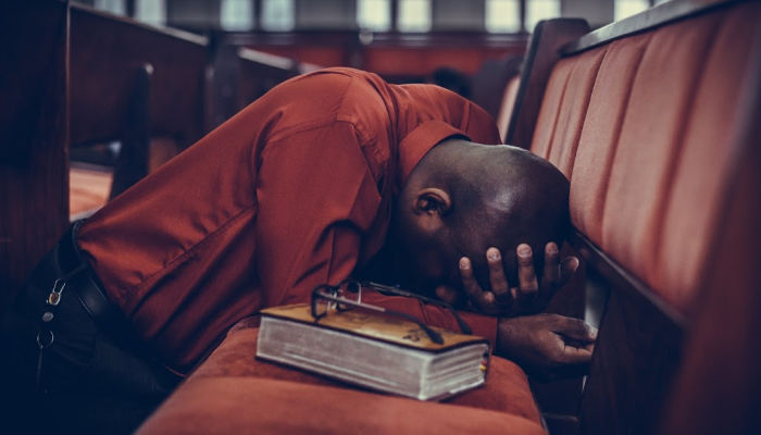 man praying in a church