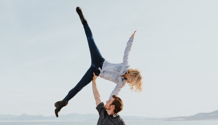 man lifting woman into the air