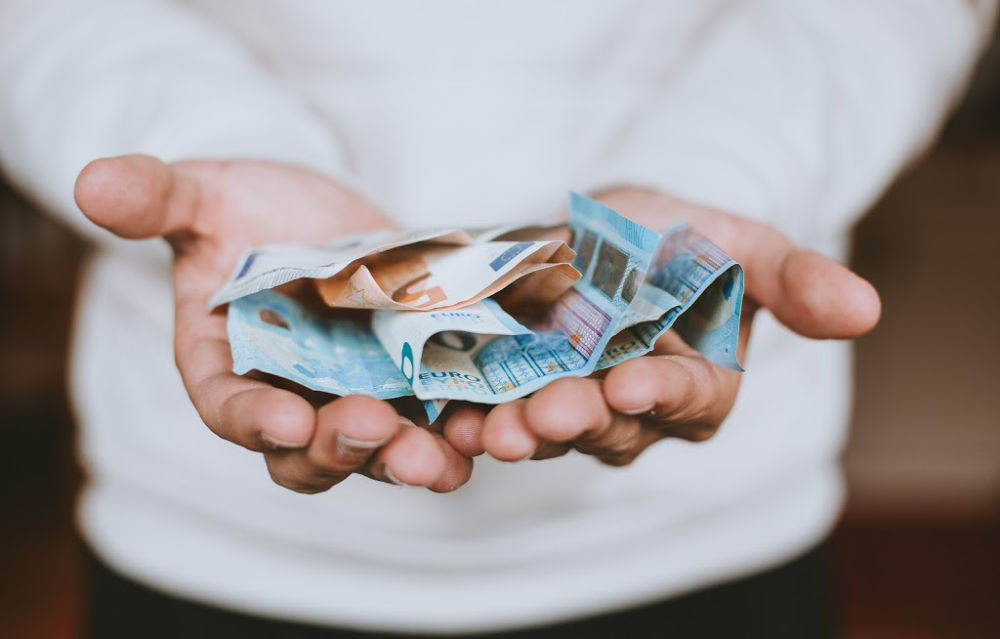 hands holding money