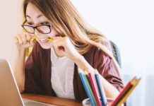 woman dealing with stress chewing on a pencil