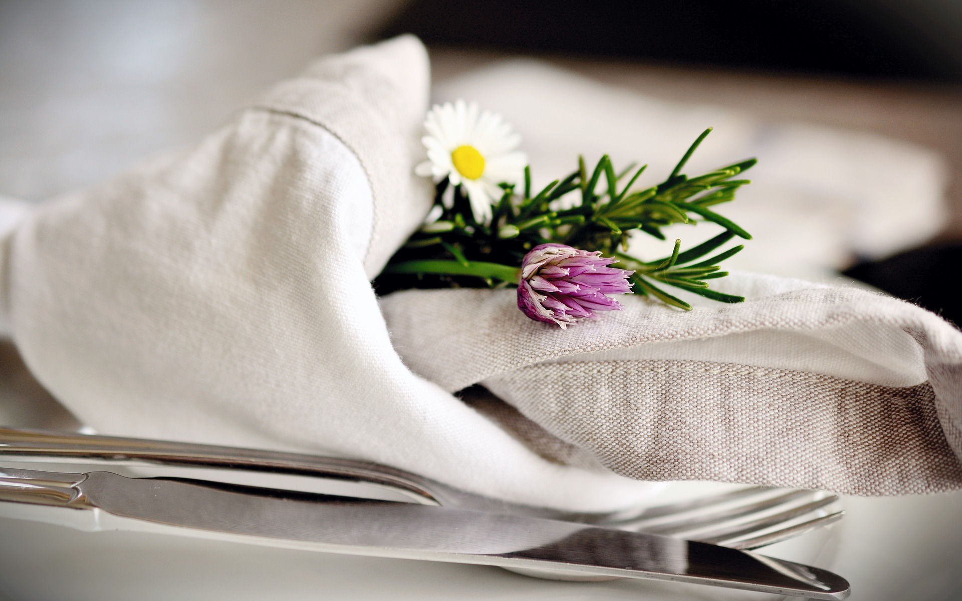 Cloth napkin and cutlery on a table. 