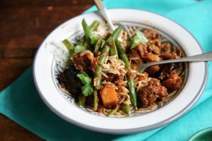 bowl of food like green beans and meat