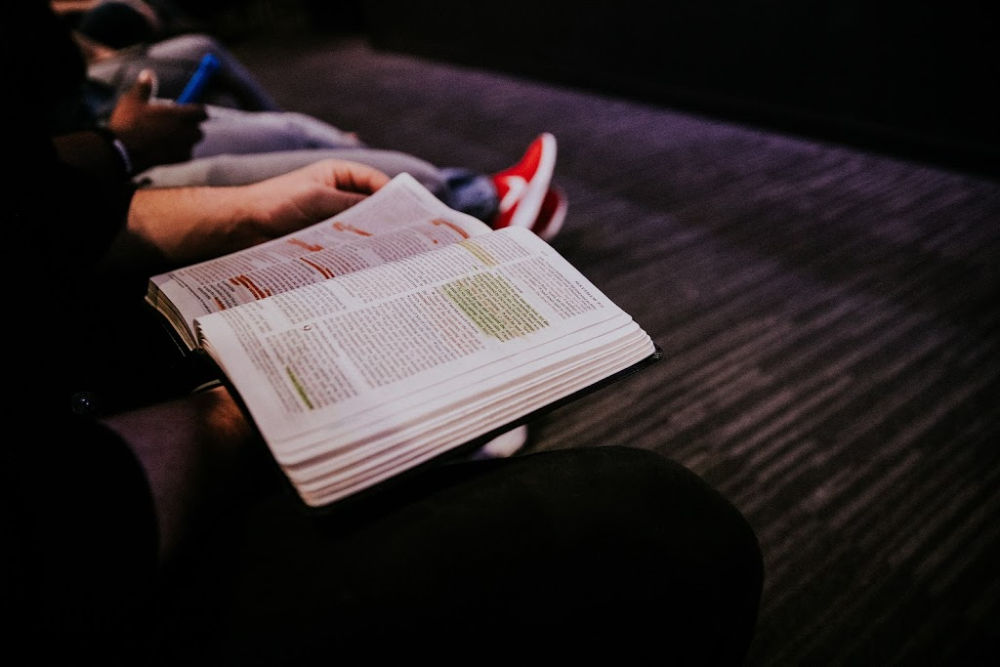 a person reading a book sitting down