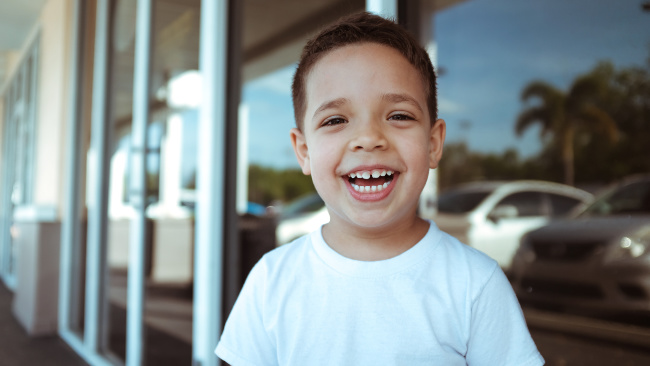 toddler boy smiling at the camera