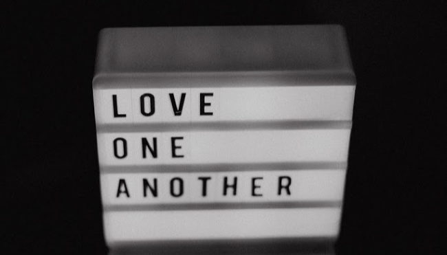 sign that says to love one another