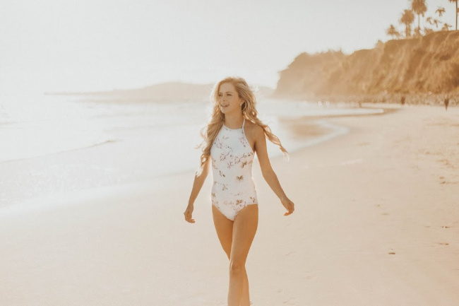 rose quartz swimsuit from geode swimwear on beach