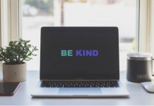 a laptop showing the words be kind