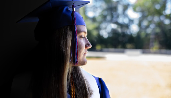 girl from the class of 2020 wearing graduation outfit