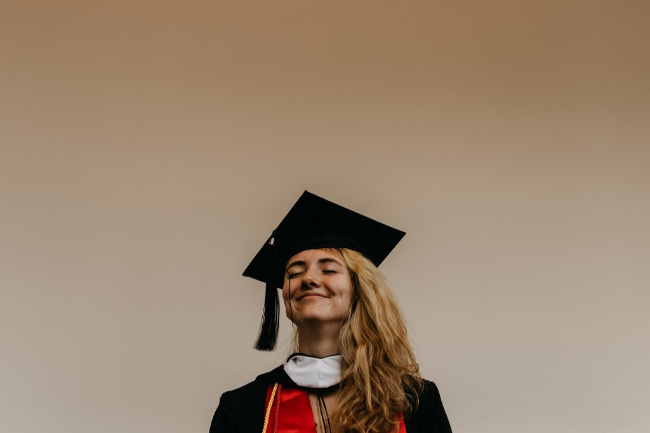 girl wearing cap and gown smiling