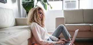 woman sitting on the floor and working from home