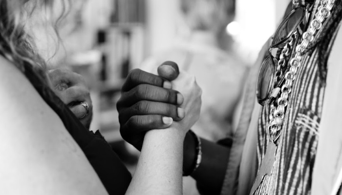 black and white hands holding together