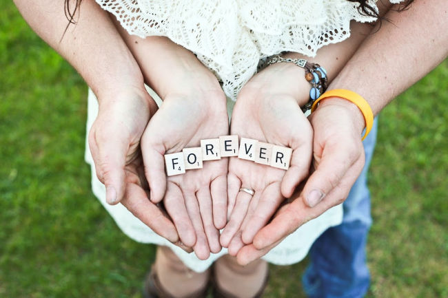 couple holding forever letters in their hands