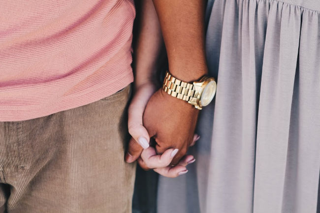 person of color holding a white persons hand