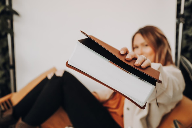 young woman holding out scriptures