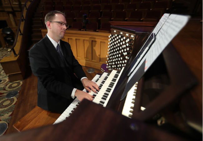 man playing keys on the organ