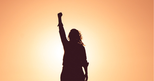 woman standing with fist in the air