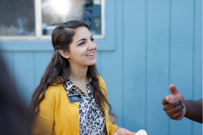 sister missionary teaching and smiling at a friend