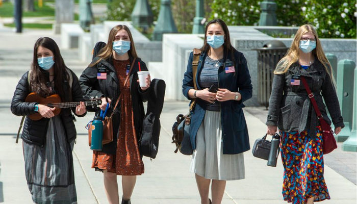 four sister missionaries serving a mission during COVID-19 wearing masks