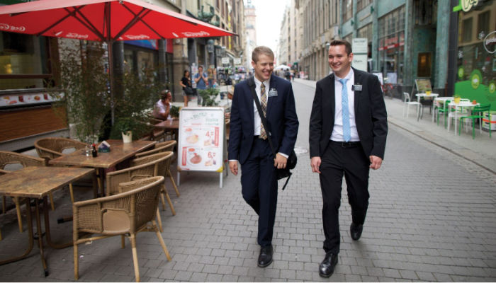 two elder missionaries walking down the street talking