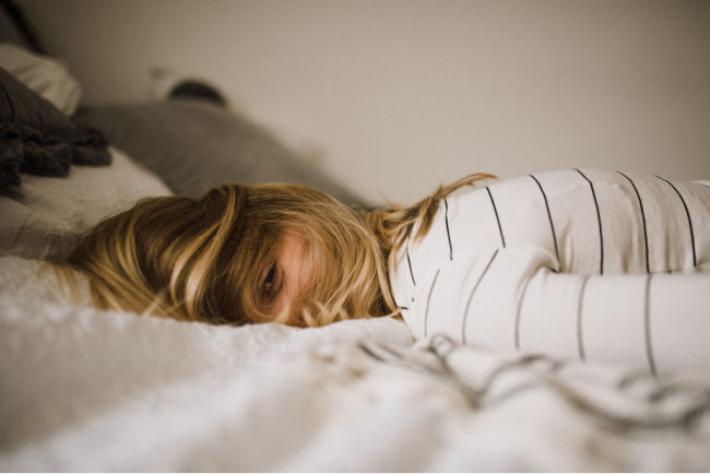 woman taking a nap in a bed